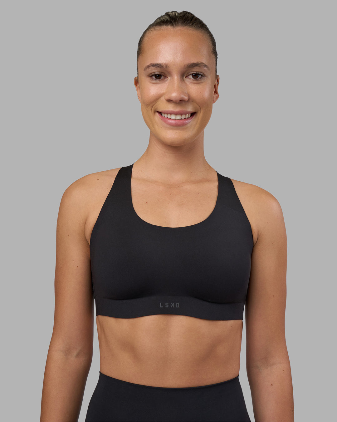 Woman wearing Stability Sports Bra - Black | Model:Charlize | Size:S (A-C Cup)