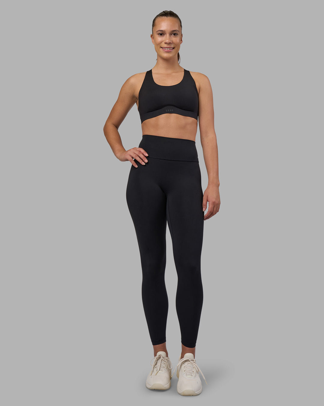 Woman wearing Stability Sports Bra - Black | Model:Charlize | Size:S (A-C Cup)