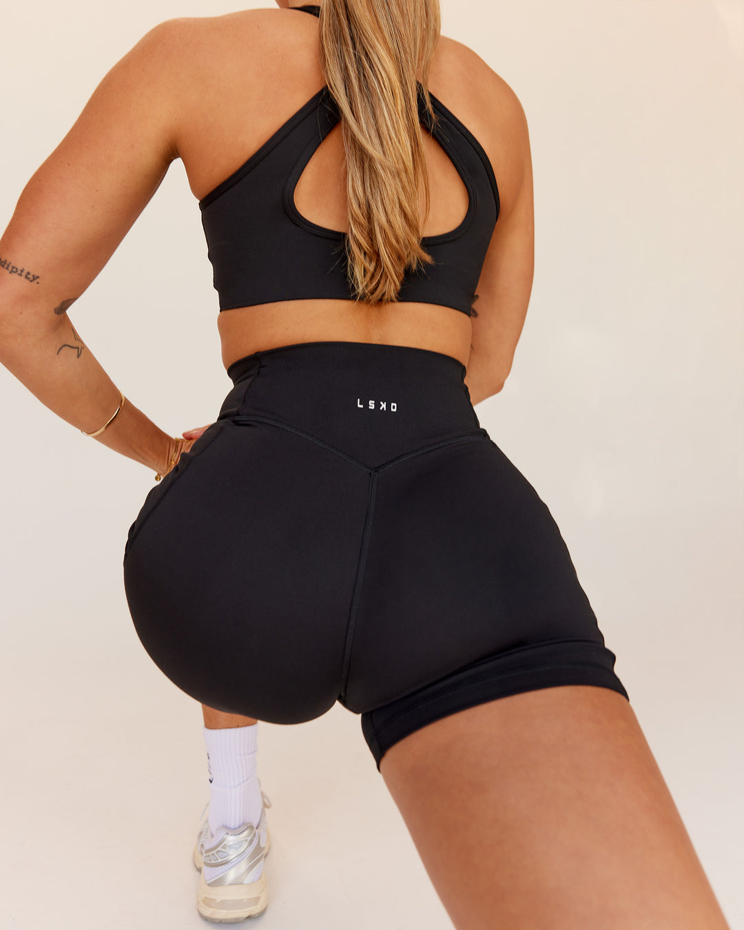 Woman wearing Fusion V-Contour Ultra High-Rise 4โ Short Pockets - Black | Model:Shae | Size:S