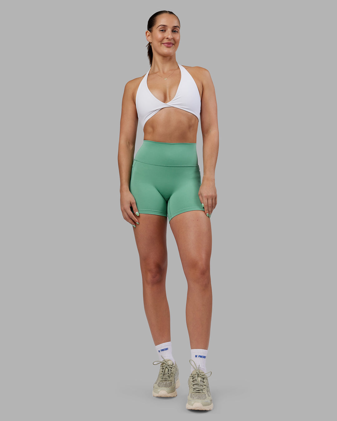 Woman wearing Abs Fusion High-Rise 4" Short Pockets - Matcha Green | Model:Abbey | Size:S