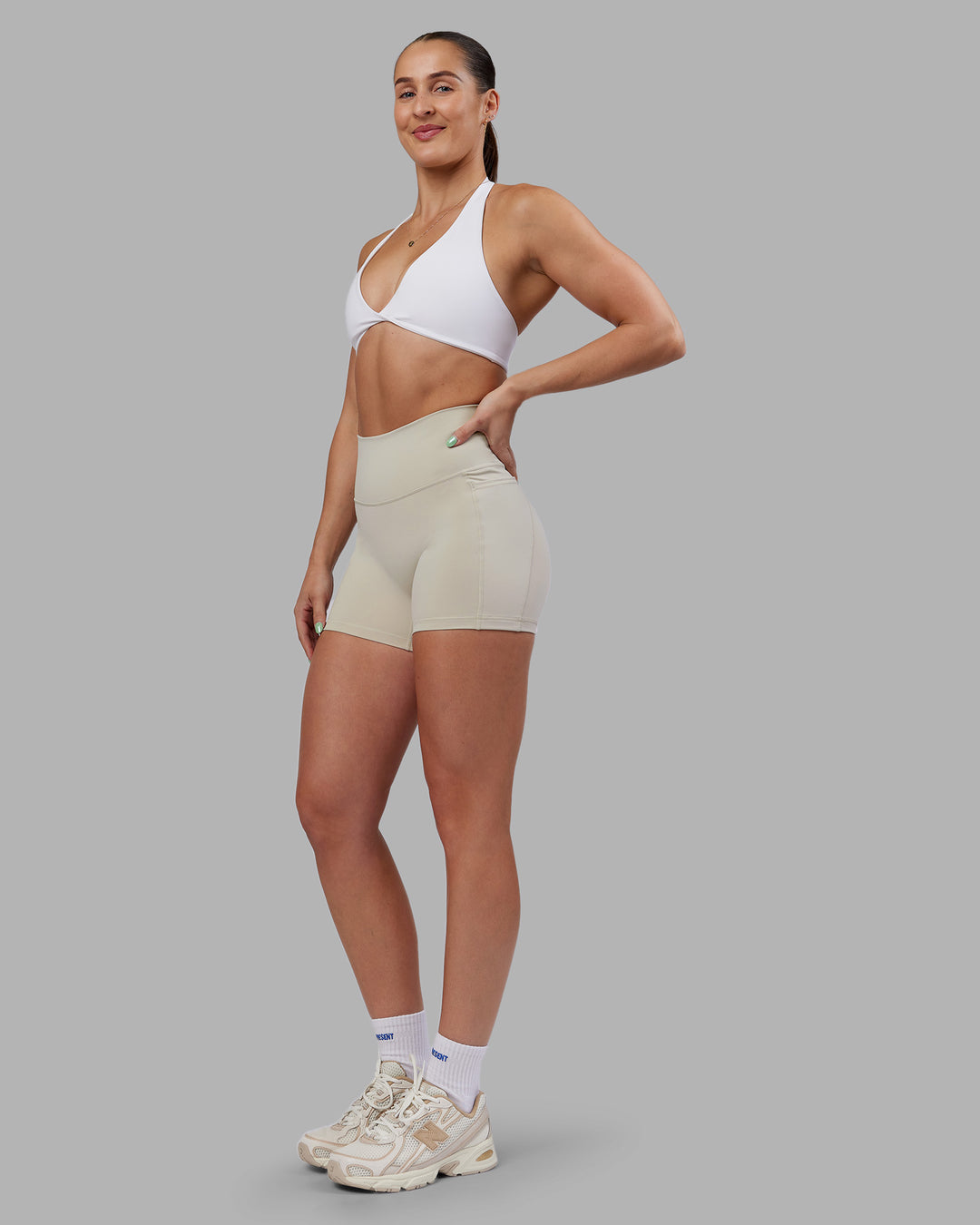 Woman wearing Abs Fusion High-Rise 4" Short Pockets - Shale Beige | Model:Abbey | Size:S