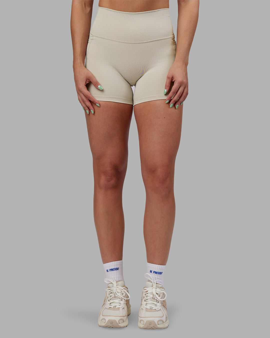 Woman wearing Abs Fusion High-Rise 4" Short Pockets - Shale Beige | Model:Abbey | Size:S