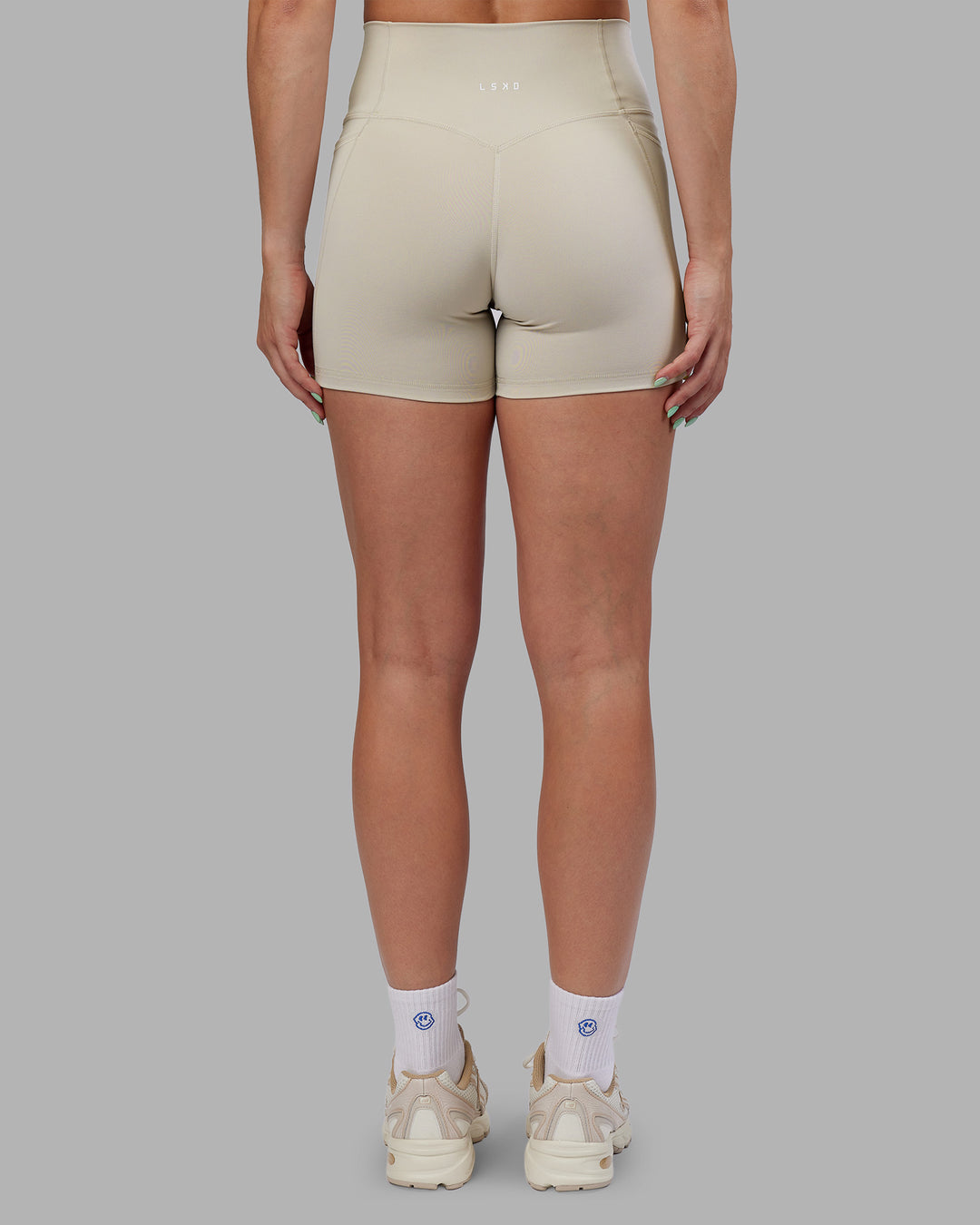 Woman wearing Abs Fusion High-Rise 4" Short Pockets - Shale Beige | Model:Abbey | Size:S