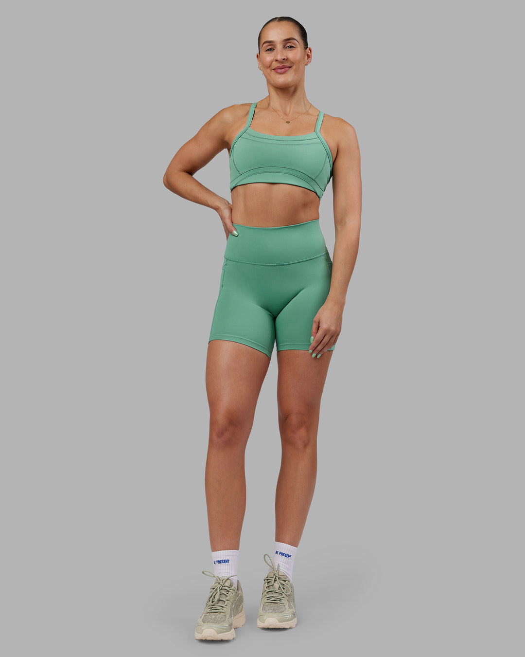 Woman wearing Abs Fusion High-Rise 6" Short Pockets - Matcha Green | Model:Abbey | Size:S