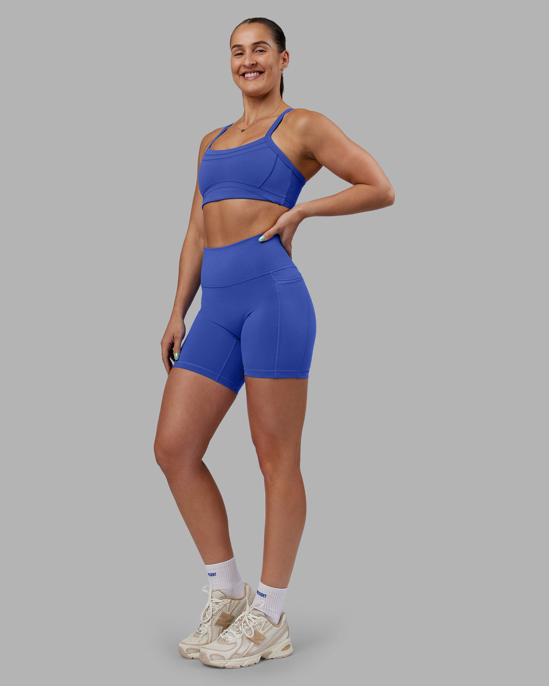 Woman wearing Abs Fusion High-Rise 6" Short Pockets - Power Cobalt | Model:Abbey | Size:S