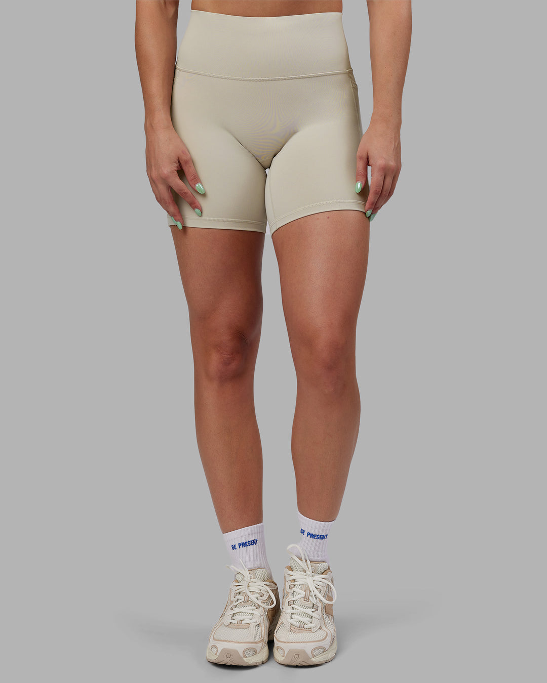 Woman wearing Abs Fusion High-Rise 6" Short Pockets - Shale Beige | Model:Abbey | Size:S