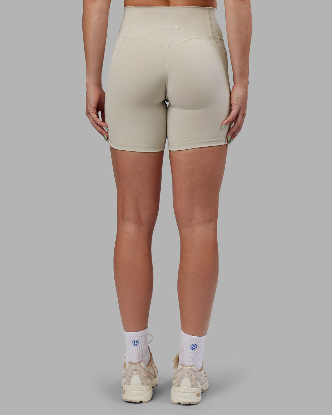 Woman wearing Abs Fusion High-Rise 6" Short Pockets - Shale Beige | Model:Abbey | Size:S