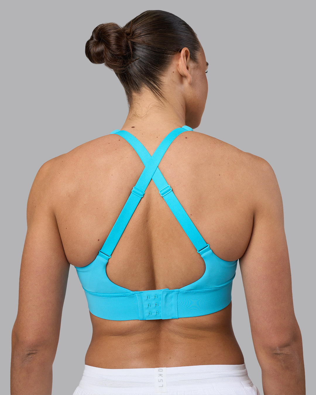 Woman wearing Accelerate Sports Bra - Blue Atoll | Model:Sophie | Size:S