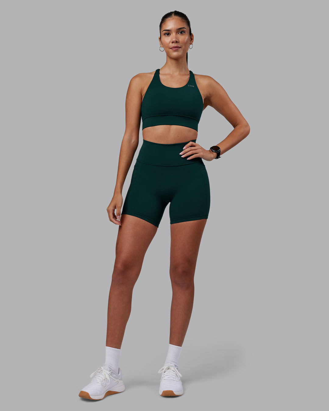 Woman wearing Accelerate Sports Bra - Dark Moss | Model:Rhiley | Size:S