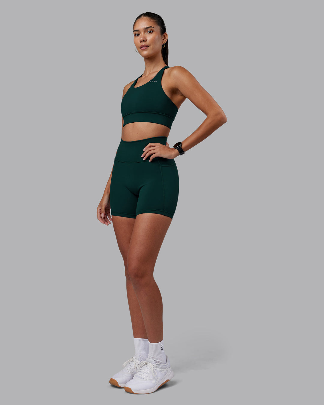 Woman wearing Accelerate Sports Bra - Dark Moss | Model:Rhiley | Size:S