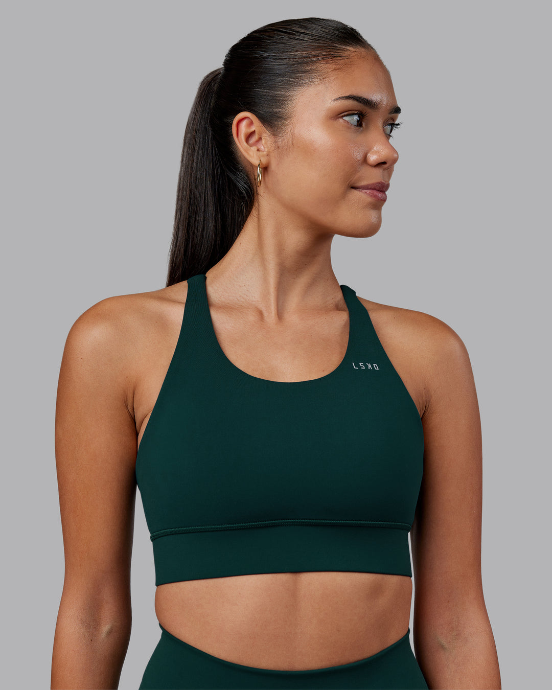 Woman wearing Accelerate Sports Bra - Dark Moss | Model:Rhiley | Size:S