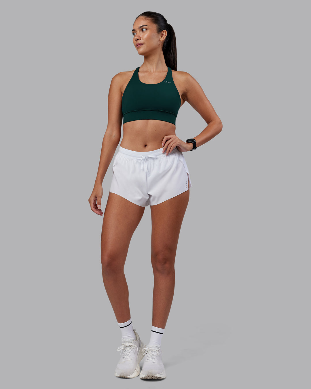 Woman wearing Accelerate Sports Bra - Dark Moss | Model:Rhiley | Size:S