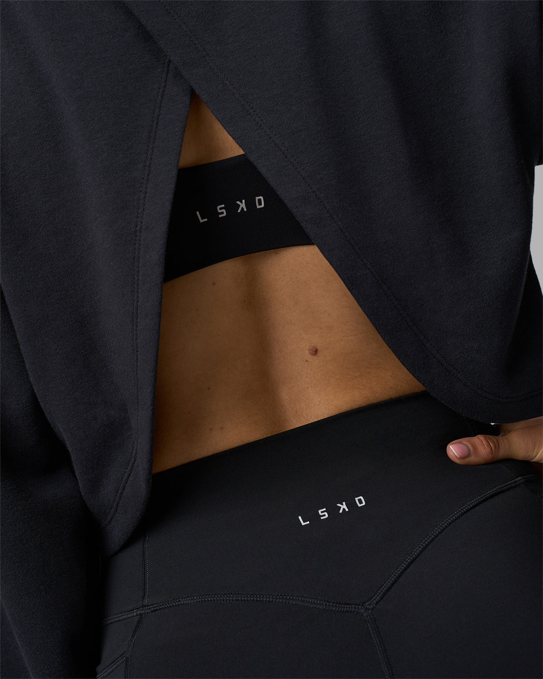 Woman wearing Breeze Open Back Sweater - Black-Black | Model:Phoebe | Size:S