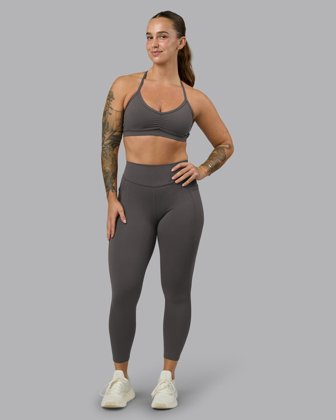 Woman wearing Elite High-Rise 7/8 Legging Pockets - Dark Storm | Model:Robyn | Size:S