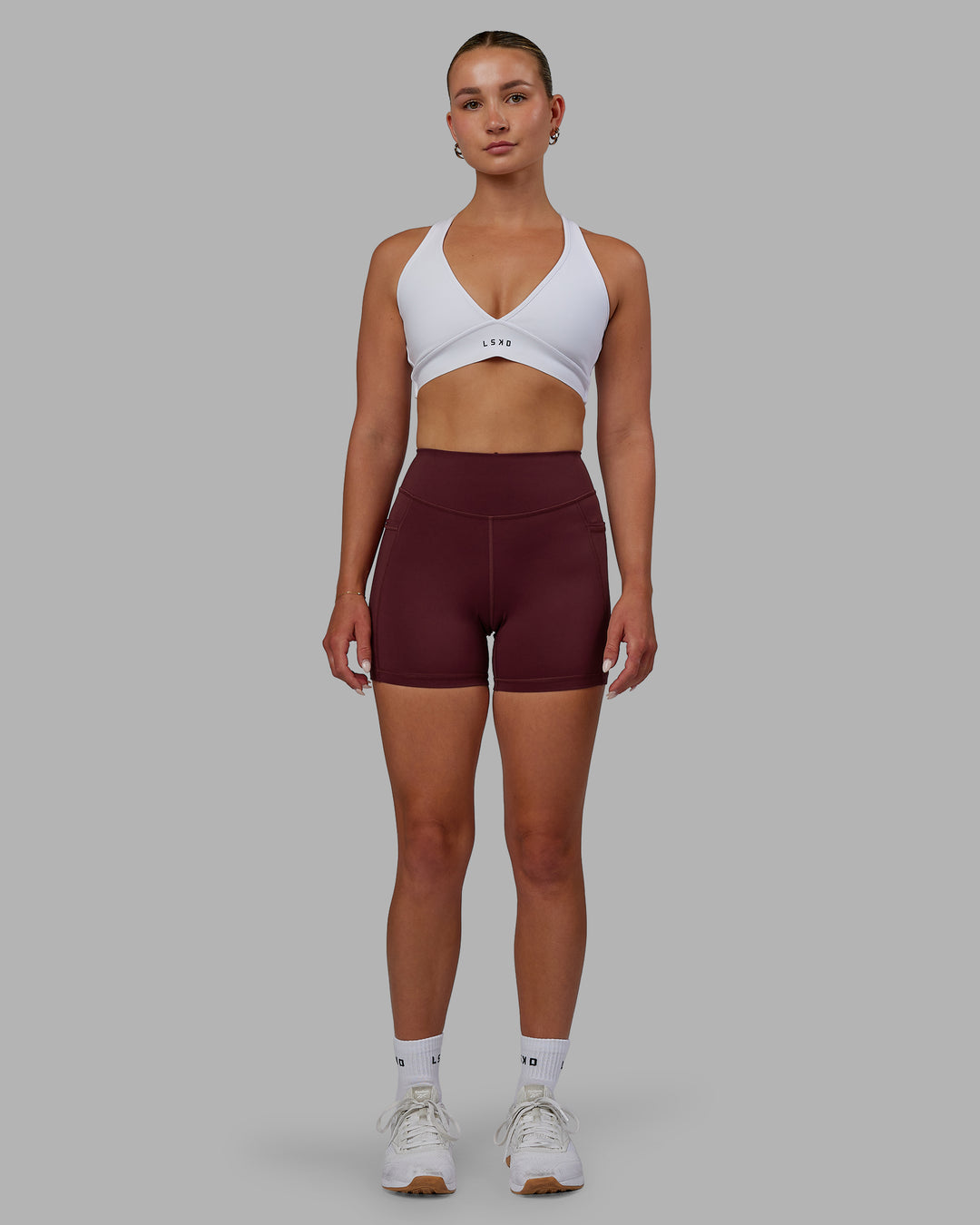 Woman wearing Elite High-Rise 4" Short Pockets - Dark Cherry