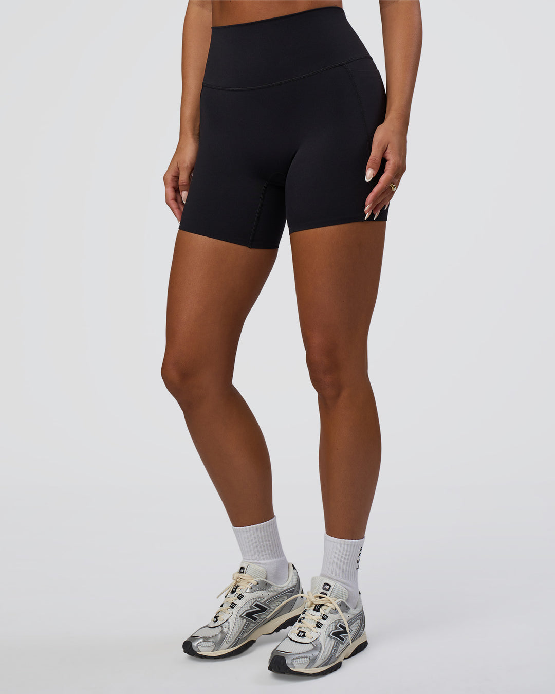 Woman wearing Elixir Defined High-Rise 6" Short Pockets - Black | Model:Bianca | Size:S