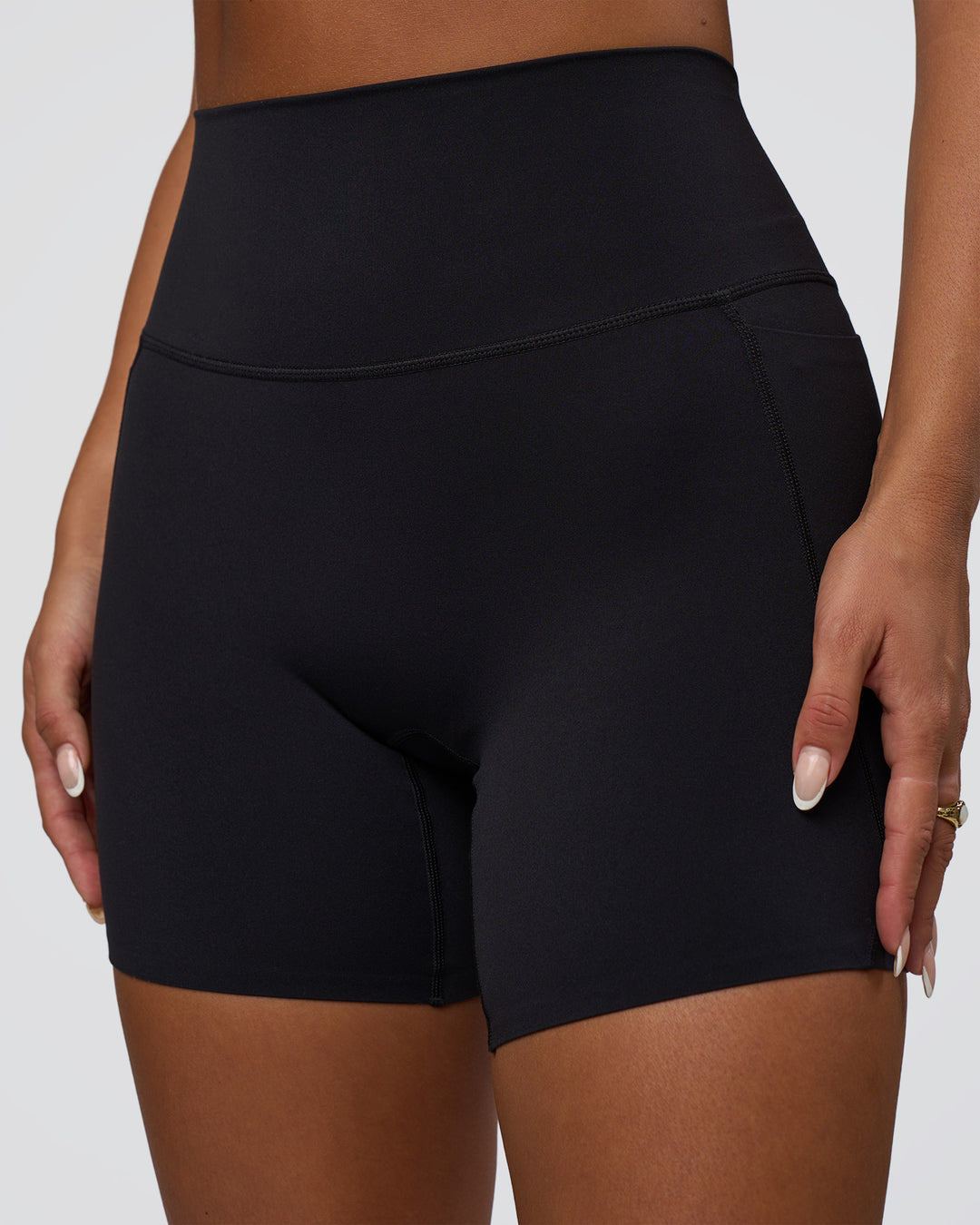 Woman wearing Elixir Defined High-Rise 6" Short Pockets - Black | Model:Bianca | Size:S
