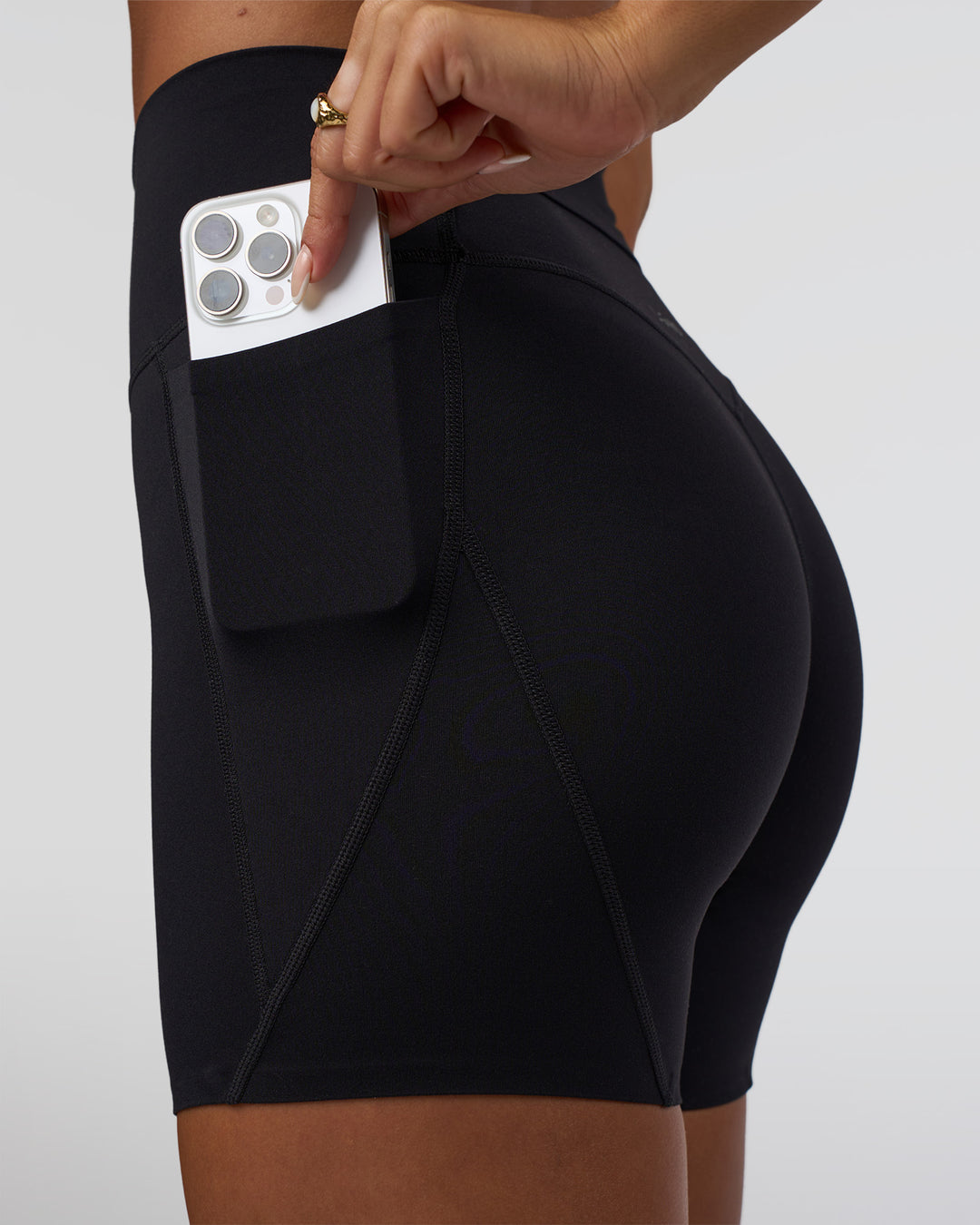 Woman wearing Elixir Defined High-Rise 6" Short Pockets - Black | Model:Bianca | Size:S