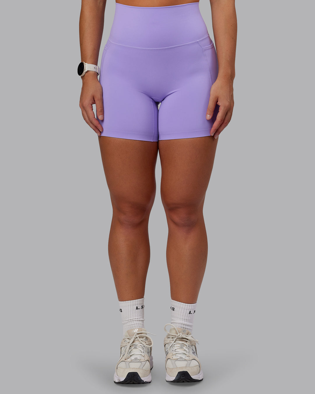 Woman wearing Elixir Ultra High-Rise 6" Short Pockets - Violet Ray | Size:S