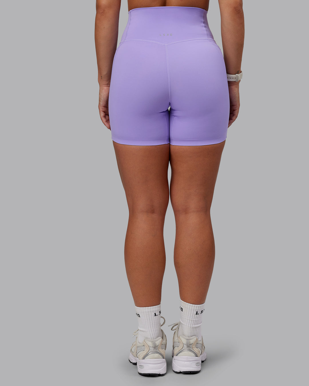 Woman wearing Elixir Ultra High-Rise 6" Short Pockets - Violet Ray | Size:S