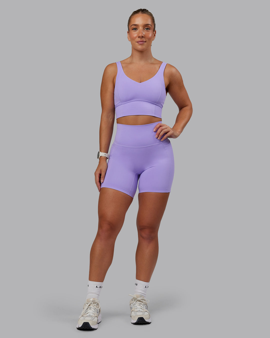 Woman wearing Elixir Ultra High-Rise 6" Short Pockets - Violet Ray | Size:S