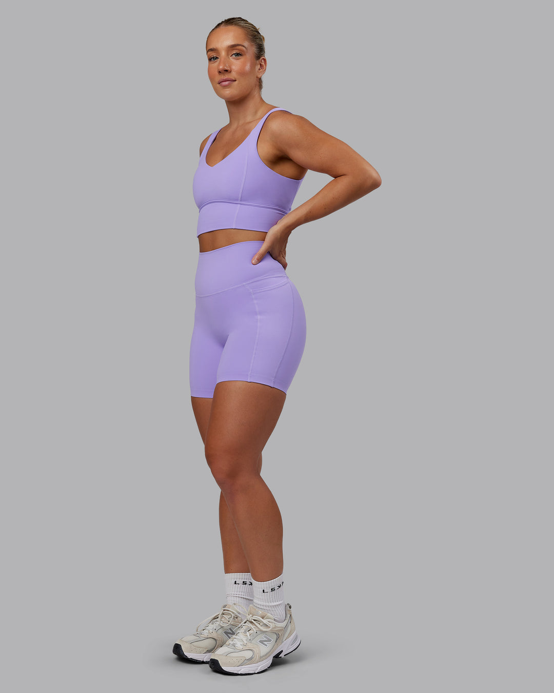 Woman wearing Elixir Ultra High-Rise 6" Short Pockets - Violet Ray | Size:S