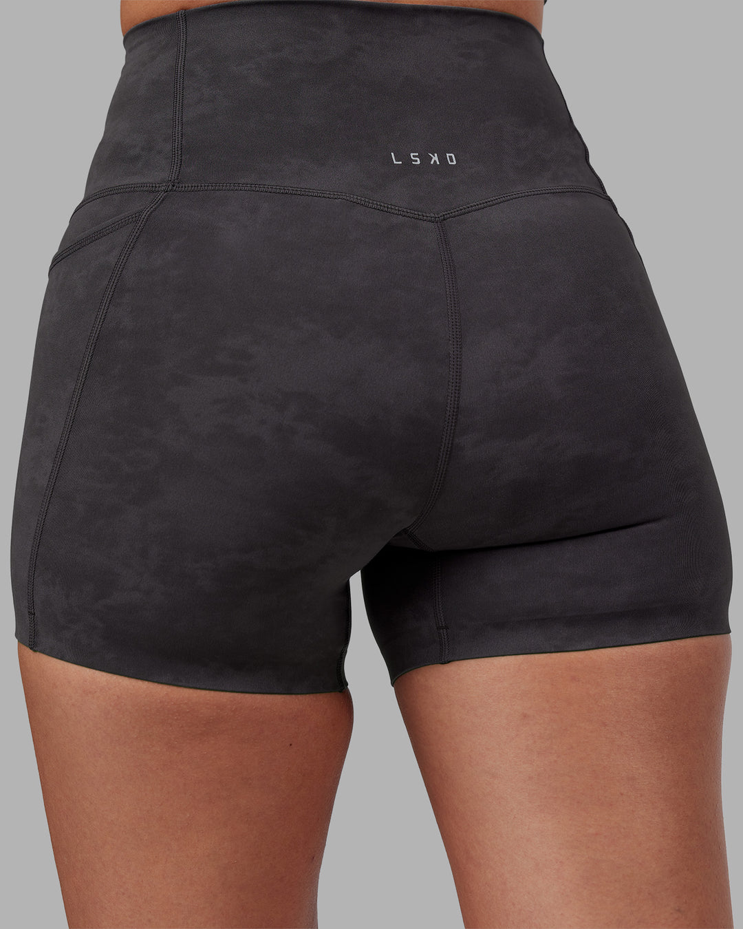 Woman wearing Elixir Ultra High-Rise 4" Short Pockets - Dark Storm Wash | Model:Rhiley | Size:S