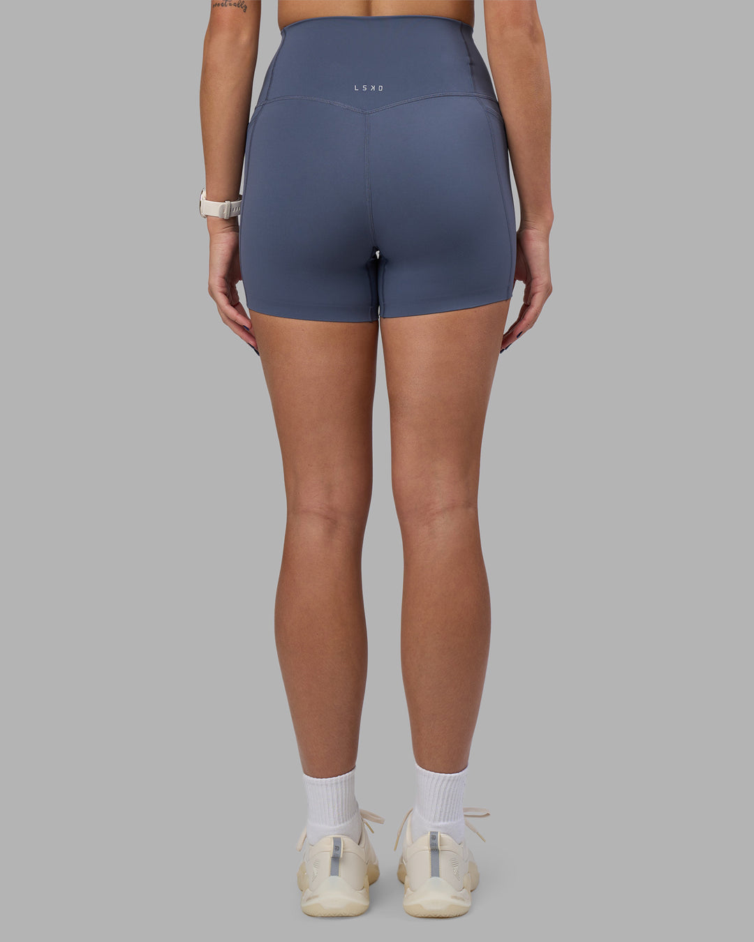 Woman wearing Elixir Ultra High-Rise 4" Short Pockets - Night Shadow | Model:Phoebe | Size:S