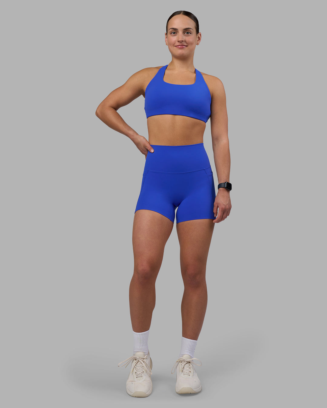 Woman wearing Elixir Ultra High-Rise 4" Short Pockets - Power Cobalt | Model:Keisha | Size:S