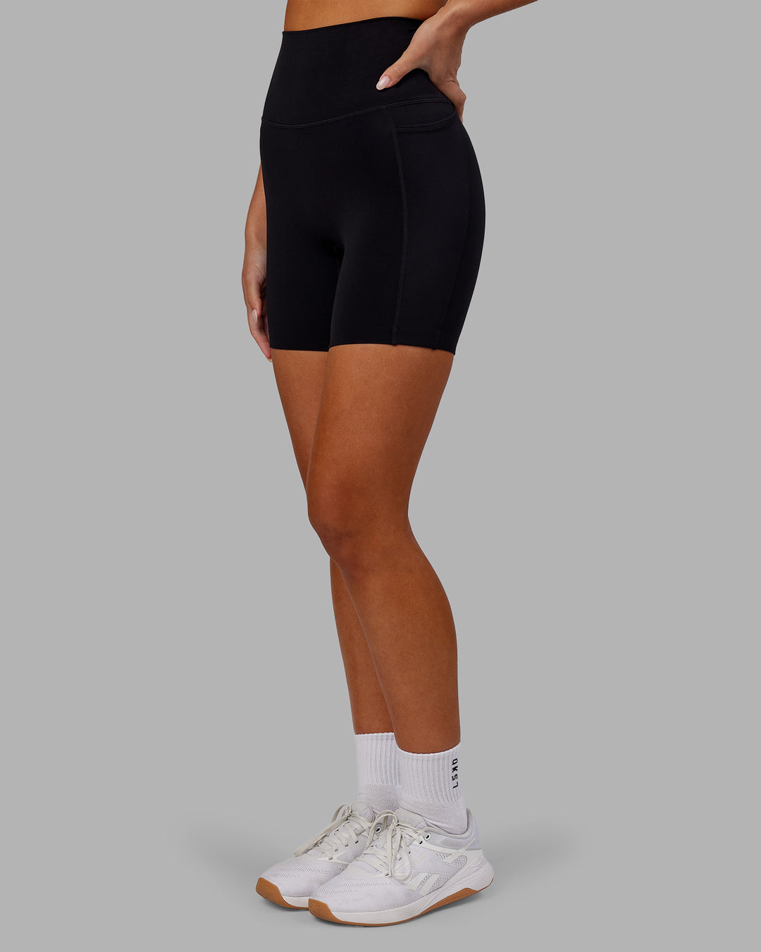 Woman wearing Elixir Ultra High-Rise 6" Short Pockets - Black | Model:Kirstyn | Size:S