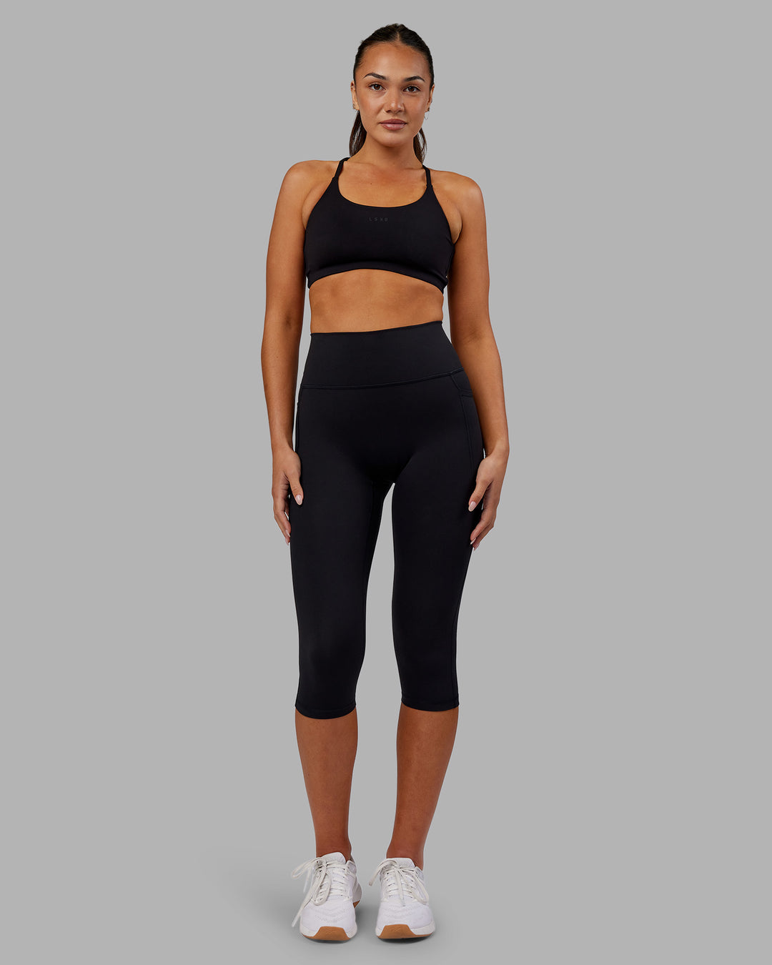 Woman wearing Fusion Ultra High-Rise 3/4 Legging Pockets - Black | Model:Kirstyn | Size:S