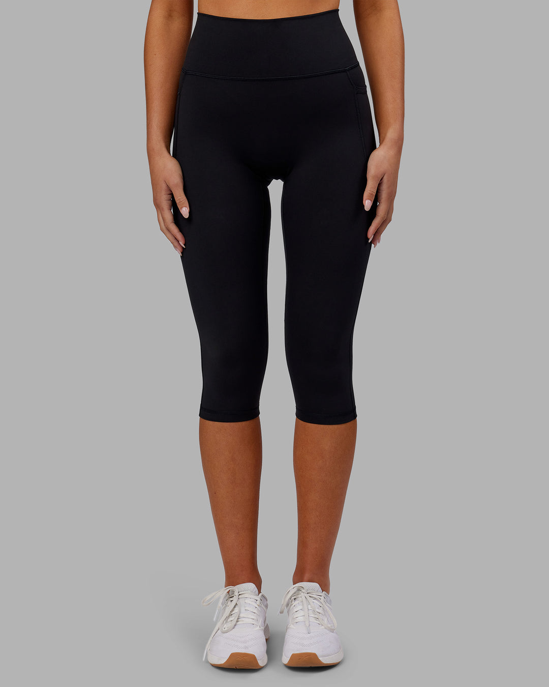 Woman wearing Fusion Ultra High-Rise 3/4 Legging Pockets - Black | Model:Kirstyn | Size:S