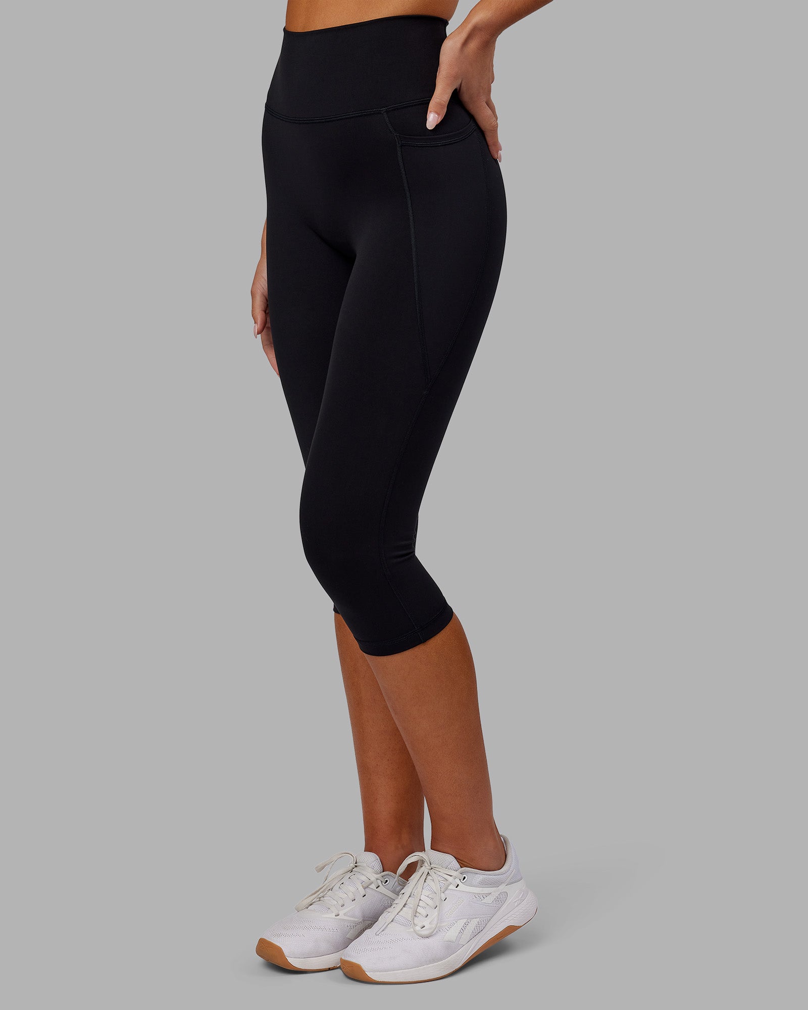 Woman wearing Fusion Ultra High-Rise 3/4 Legging Pockets - Black | Model:Kirstyn | Size:S