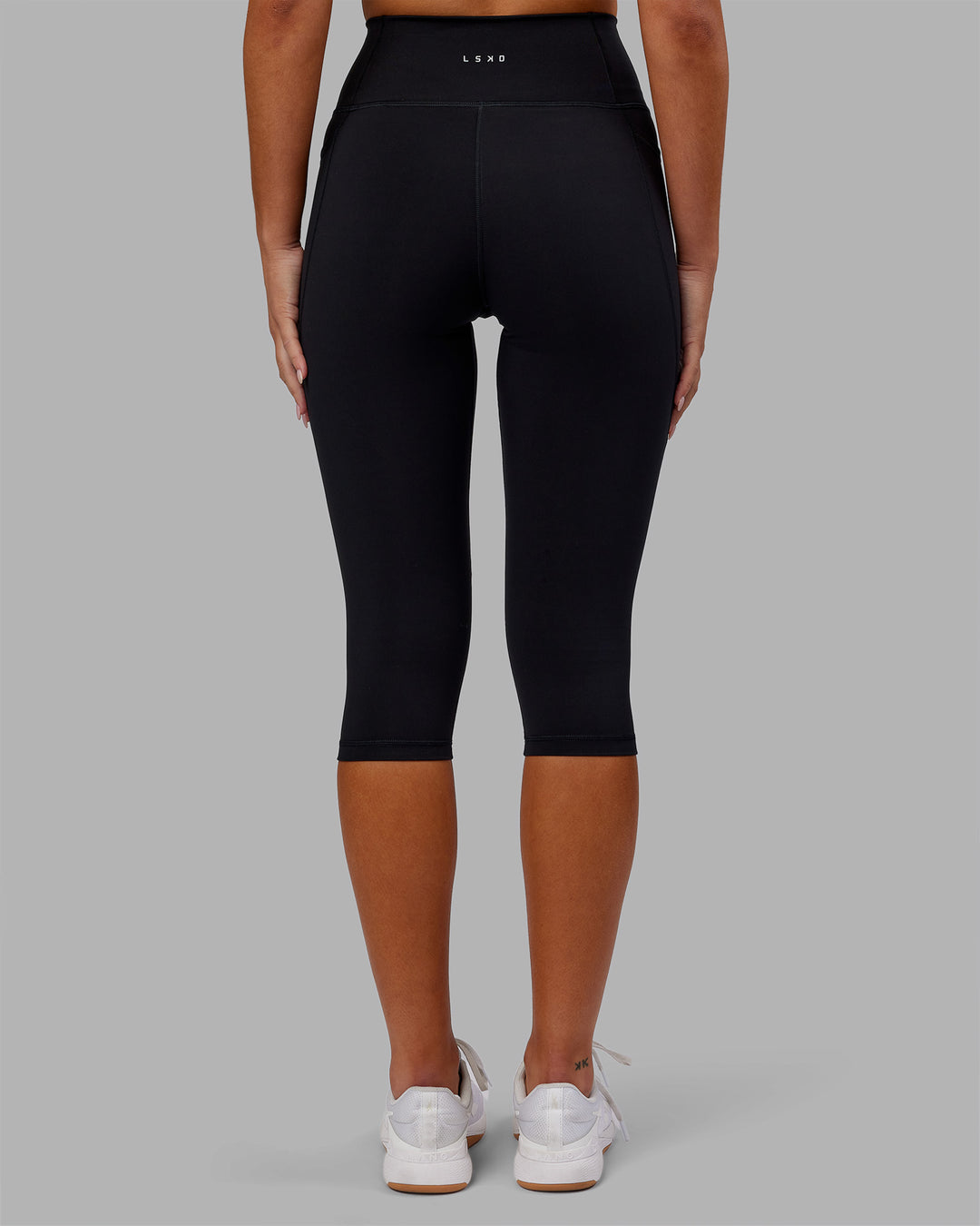 Woman wearing Fusion Ultra High-Rise 3/4 Legging Pockets - Black | Model:Kirstyn | Size:S