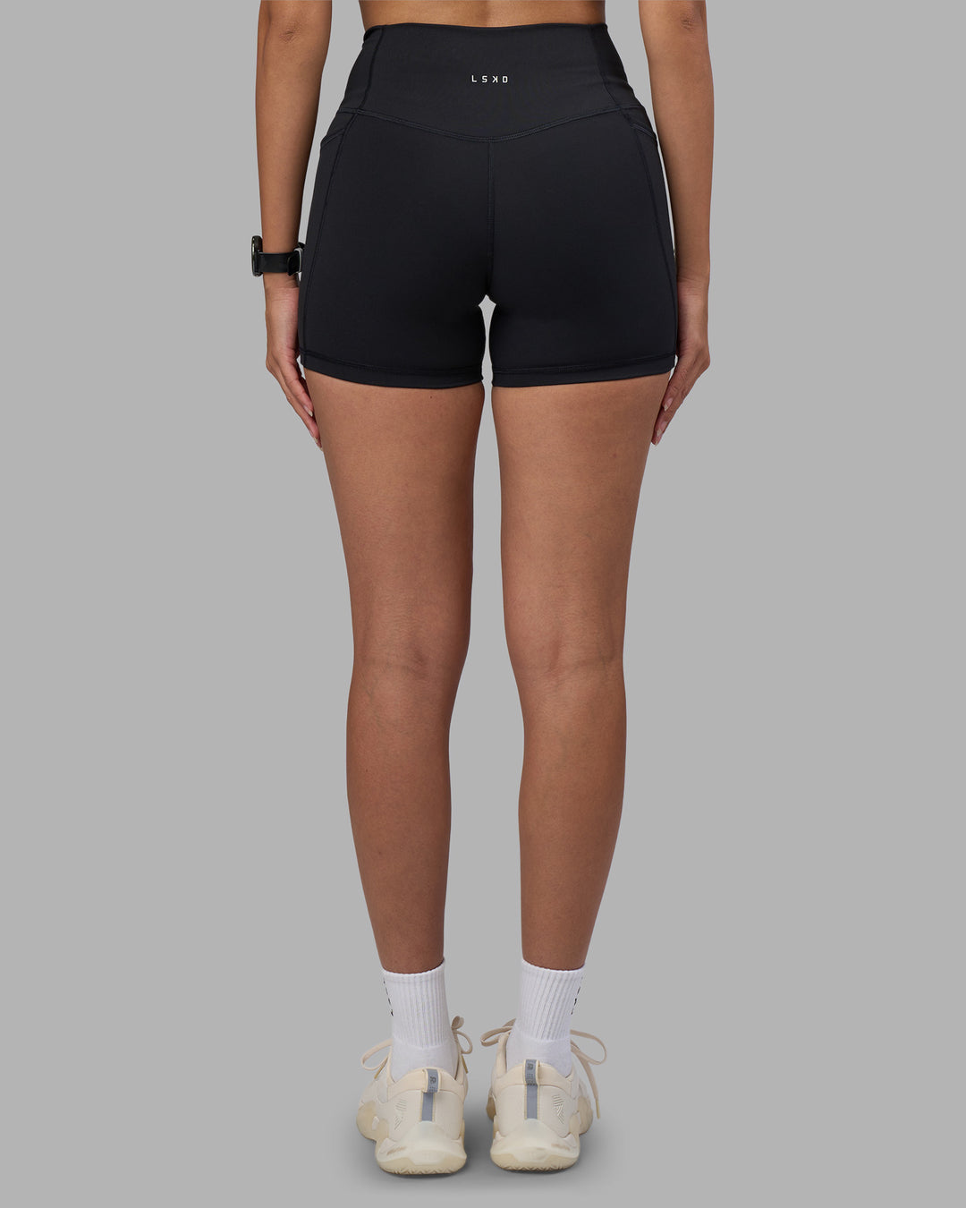 Woman wearing Fusion High-Rise 4" Short Pockets - Black | Model:Rhiley | Size:S