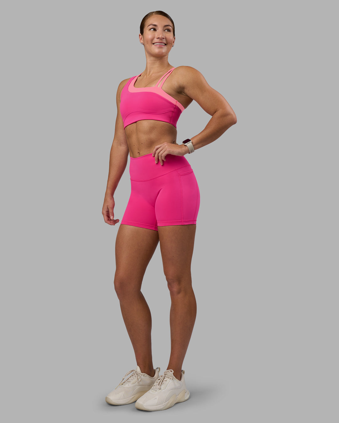 Woman wearing Fusion High-Rise 4" Short Pockets - Ultra Pink | Model:Hannah | Size:S