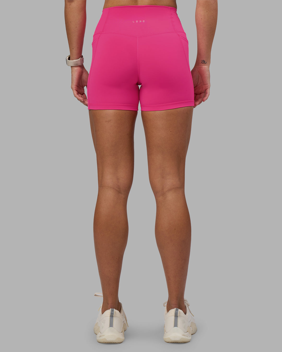 Woman wearing Fusion High-Rise 4" Short Pockets - Ultra Pink | Model:Hannah | Size:S