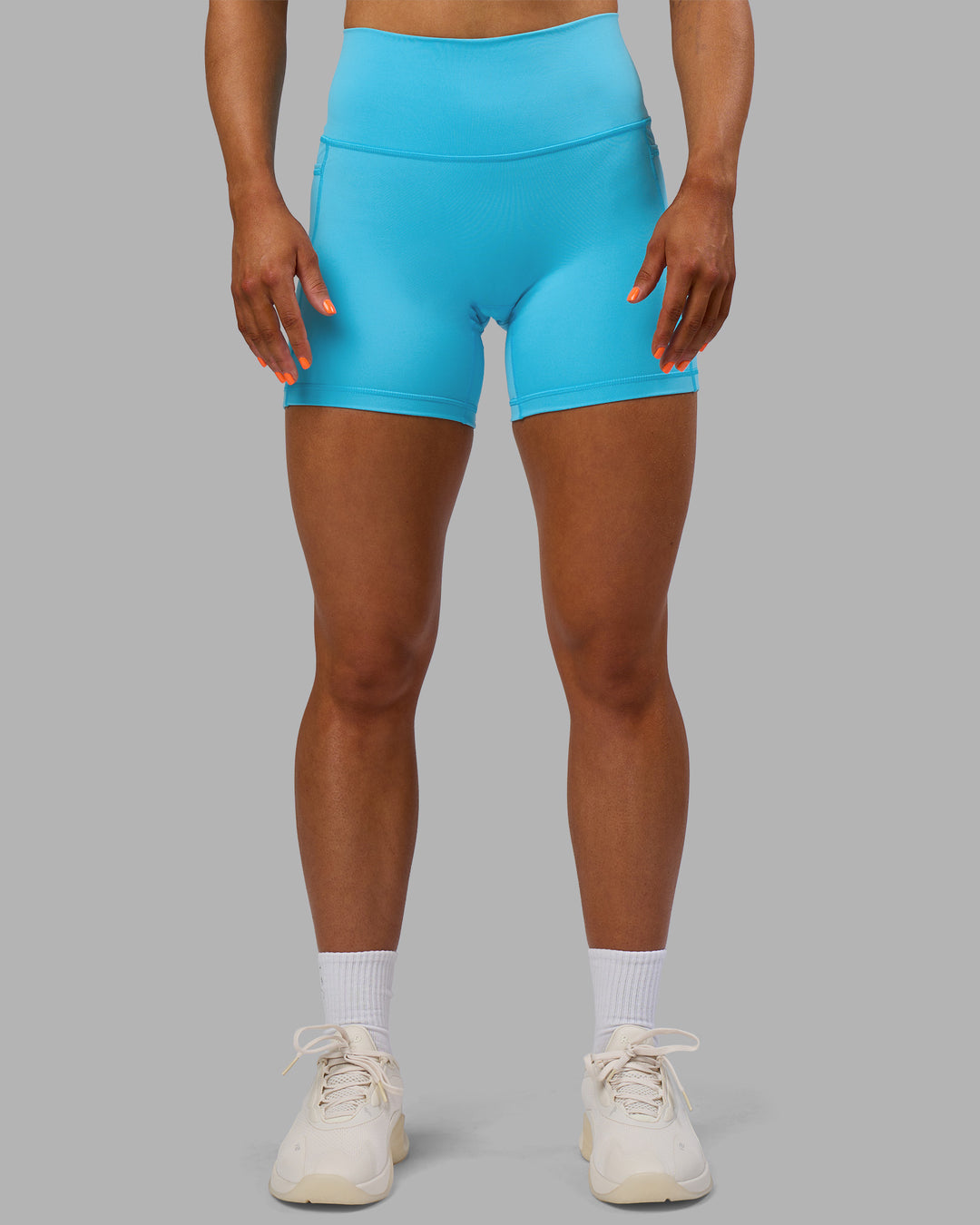 Woman wearing Fusion High-Rise 6" Short Pockets - Blue Atoll | Model:Georgia | Size:S