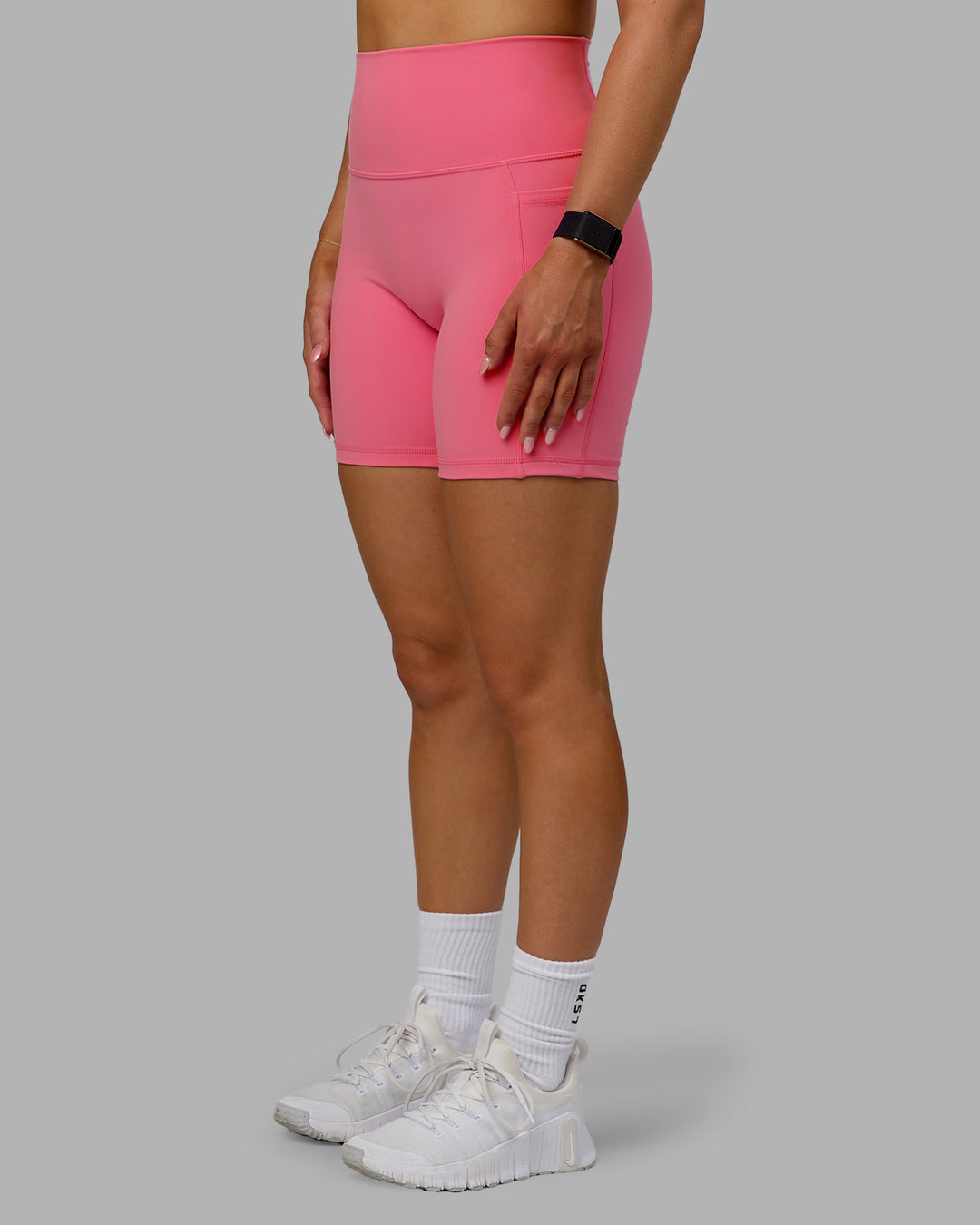 Woman wearing Fusion Ultra High-Rise 6" Short Pockets - Pink Lemonade | Model:Halle | Size:S