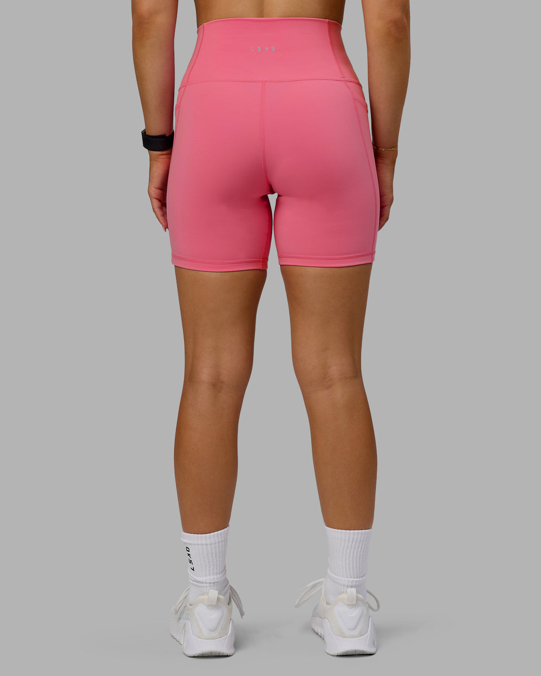 Woman wearing Fusion Ultra High-Rise 6" Short Pockets - Pink Lemonade | Model:Halle | Size:S