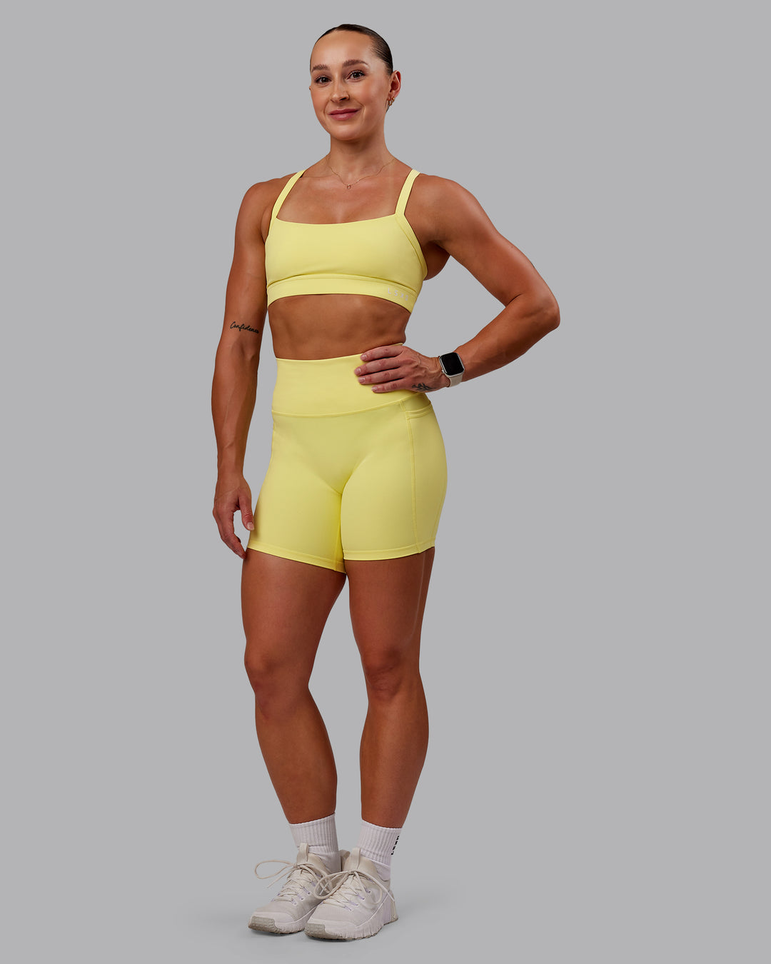 Woman wearing Fusion Ultra High-Rise 6" Short Pockets - Lemon Fizz | Model:Amber | Size:S