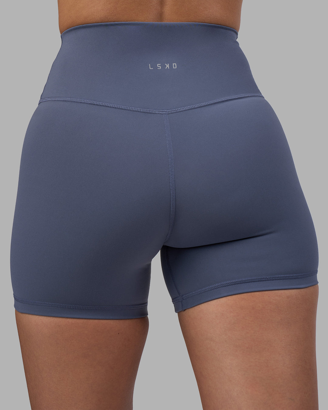 Woman wearing Fusion Ultra High-Rise 4" Short - Night Shadow | Model:Rhiley | Size:S