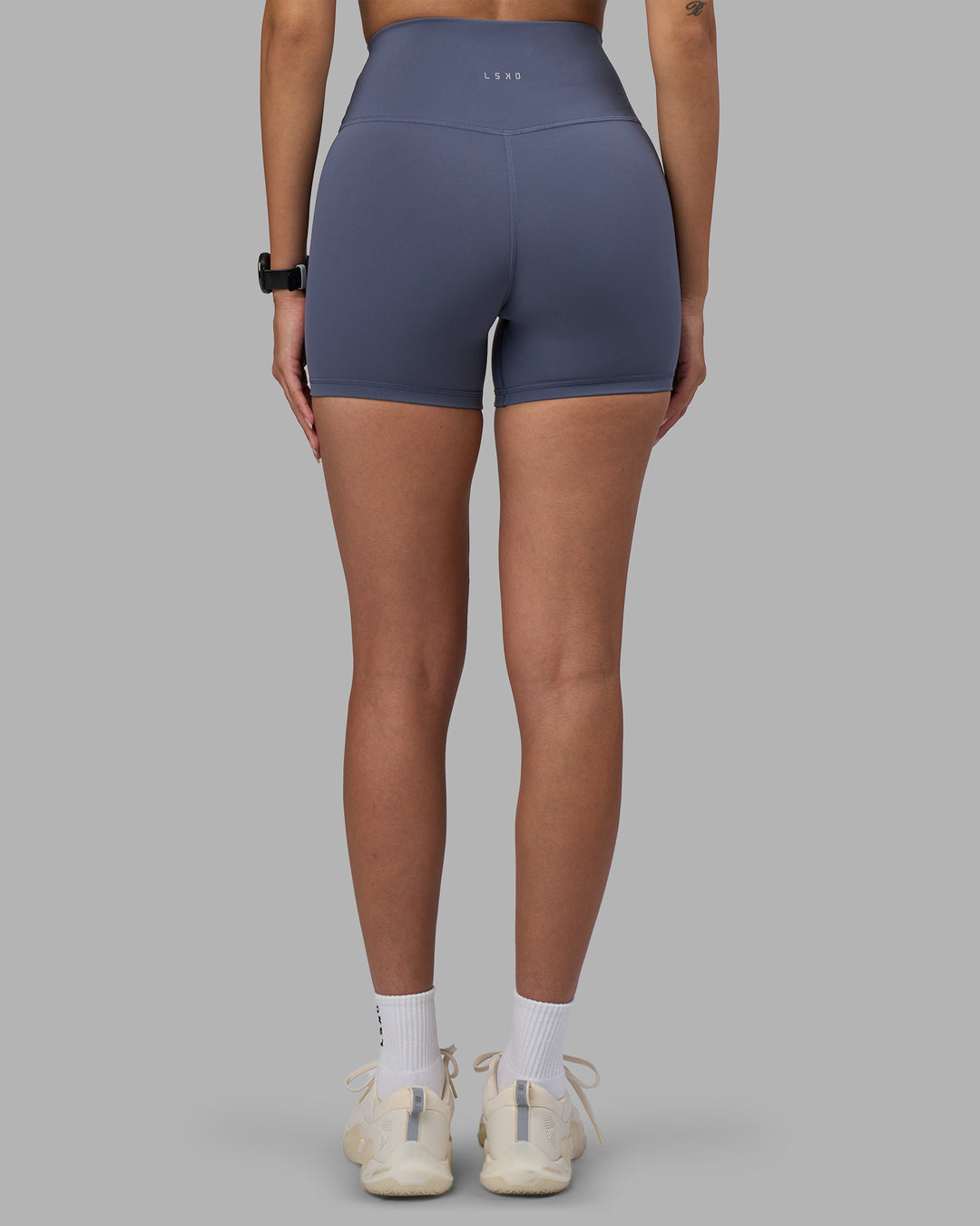 Woman wearing Fusion Ultra High-Rise 4" Short - Night Shadow | Model:Rhiley | Size:S
