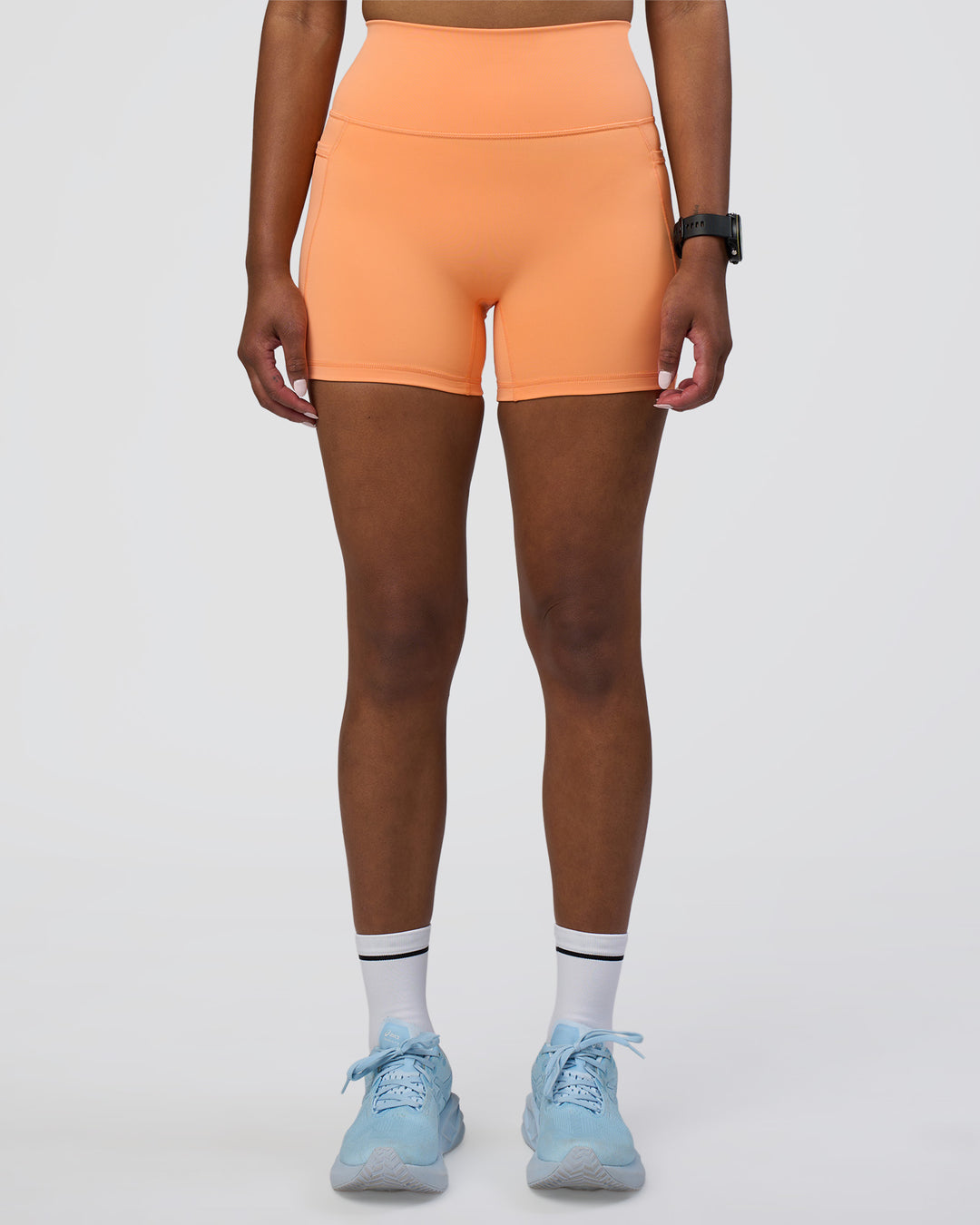 Woman wearing Fusion Ultra High-Rise 4" Short Pockets - Cantaloupe | Model:Rica | Size:S