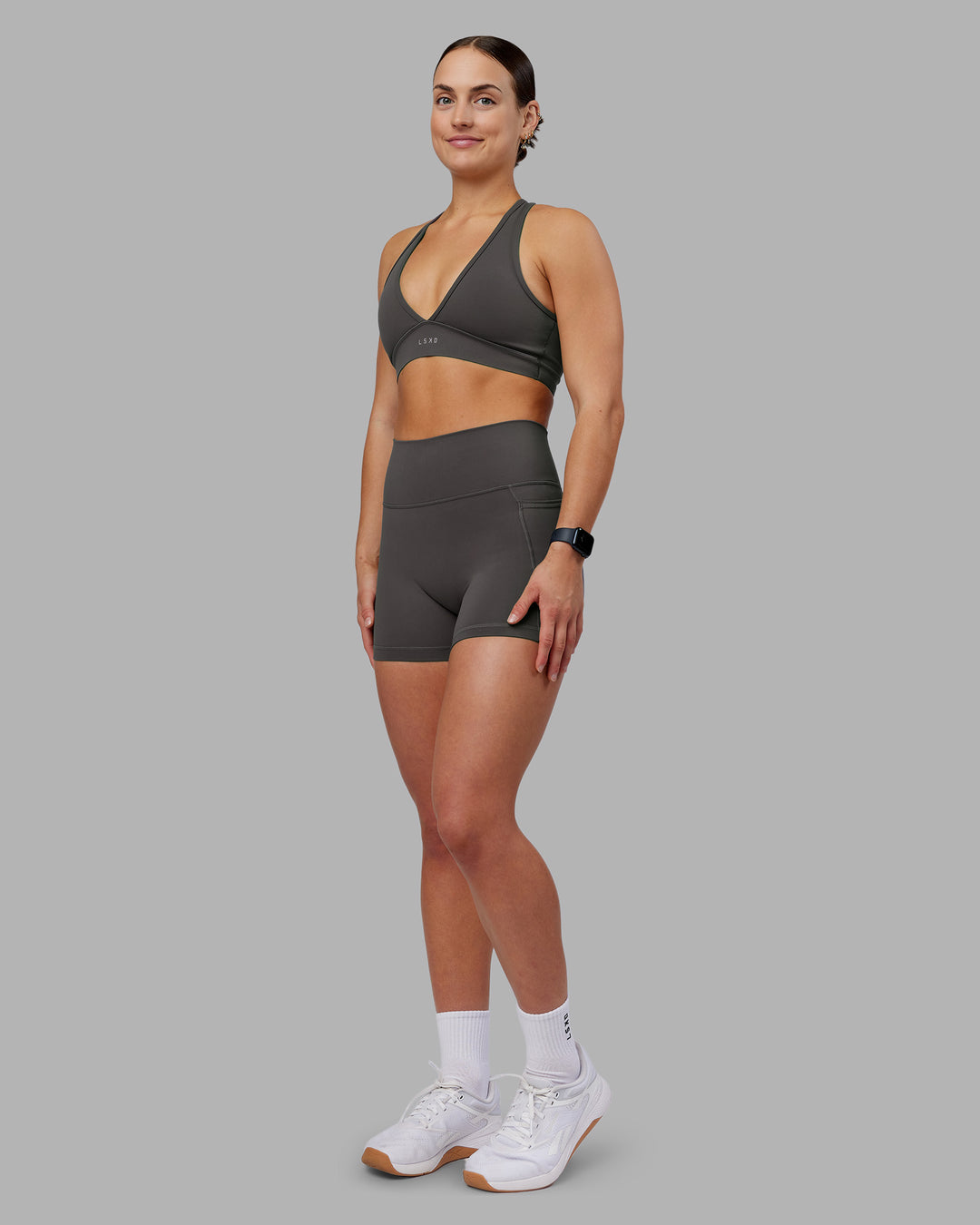 Woman wearing Fusion Ultra High-Rise 4" Short Pockets - Dark Storm | Model:Keisha | Size:S