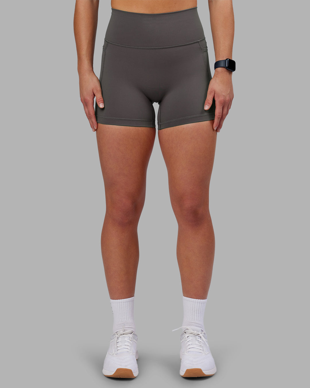 Woman wearing Fusion Ultra High-Rise 4" Short Pockets - Dark Storm | Model:Keisha | Size:S