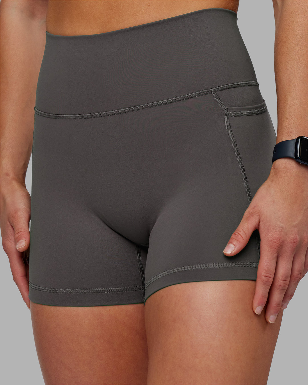 Woman wearing Fusion Ultra High-Rise 4" Short Pockets - Dark Storm | Model:Keisha | Size:S