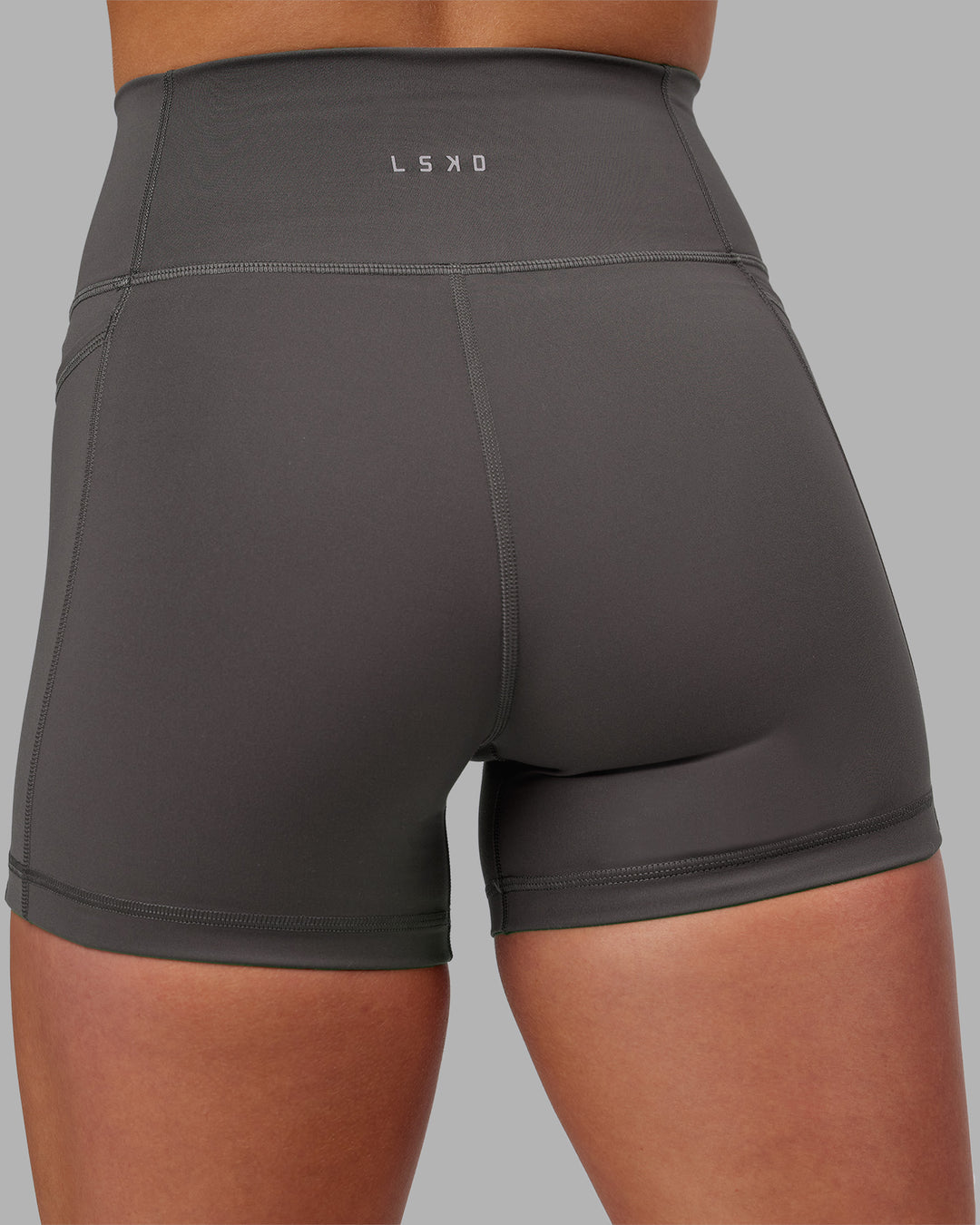 Woman wearing Fusion Ultra High-Rise 4" Short Pockets - Dark Storm | Model:Keisha | Size:S
