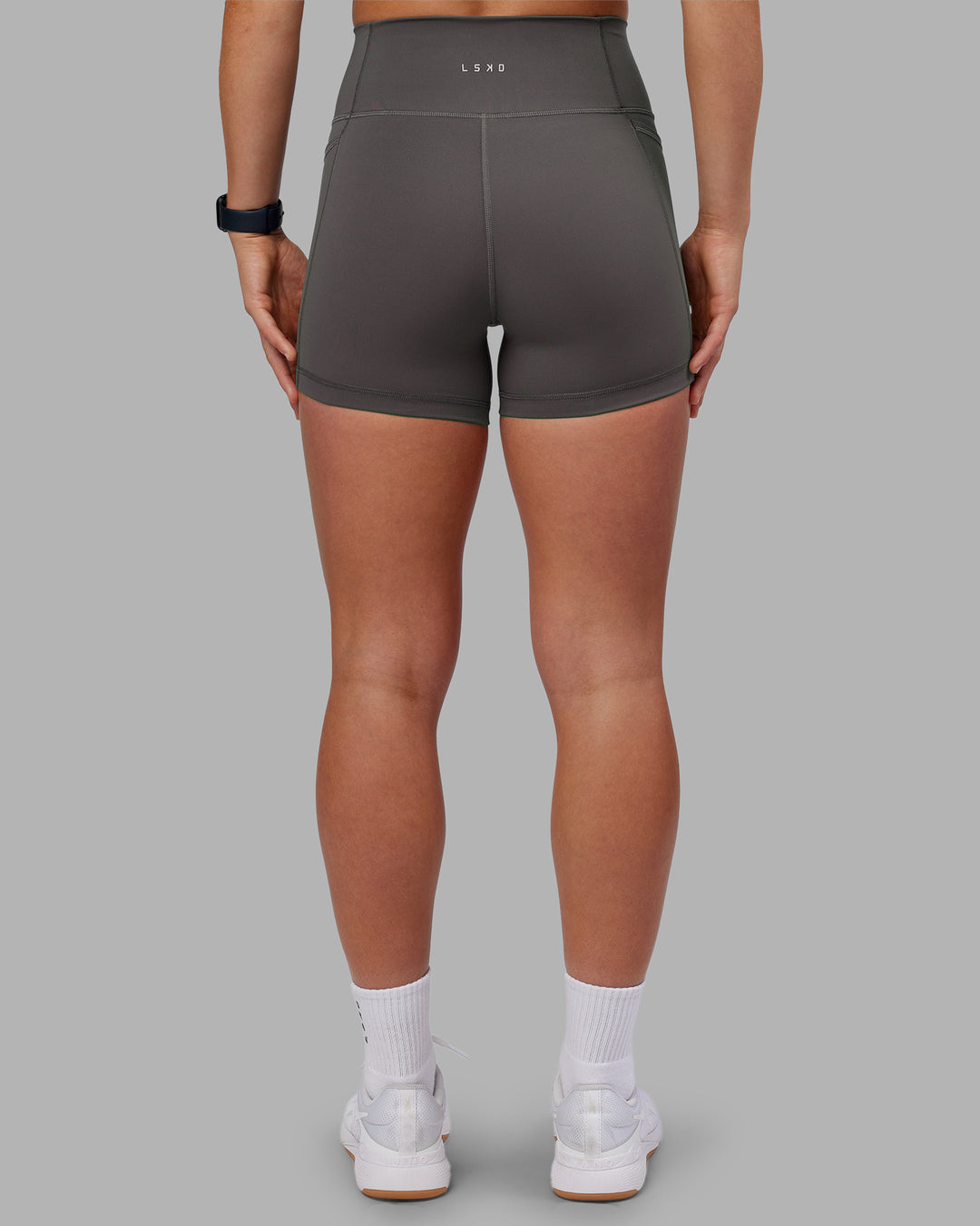 Woman wearing Fusion Ultra High-Rise 4" Short Pockets - Dark Storm | Model:Keisha | Size:S