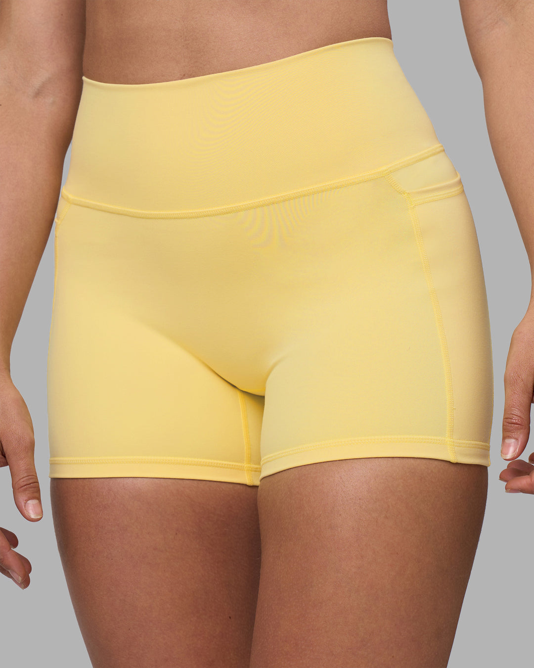 Woman wearing Fusion Ultra High-Rise 4" Short Pockets - Lemon | Model:Sophie | Size:S